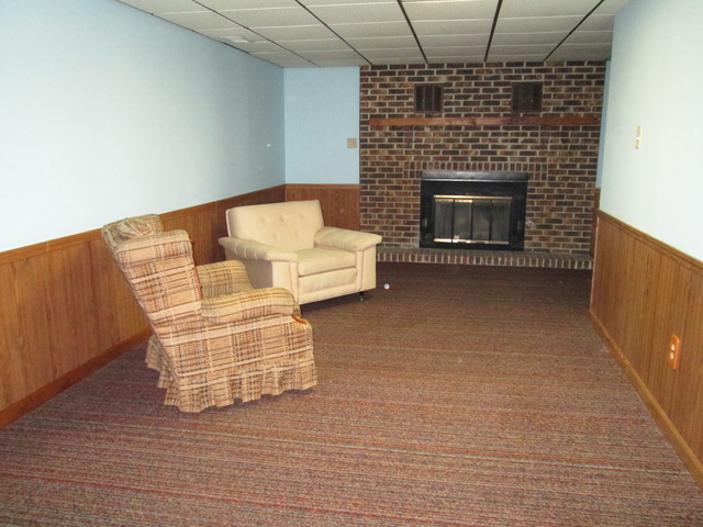 600 Schoolgate Road New Lenox, IL 60451 - Photo 12 of 24 a living room with furniture wooden floor and a fireplace
