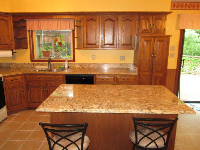 600 Schoolgate Road New Lenox, IL 60451 - Photo 4 of 24 a kitchen with a sink and wooden cabinets