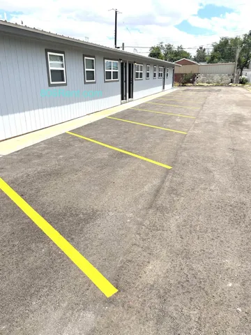 a swimming pool with an outdoor seating and a yard