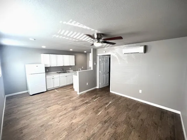 a view of a kitchen with a sink and a refrigerator
