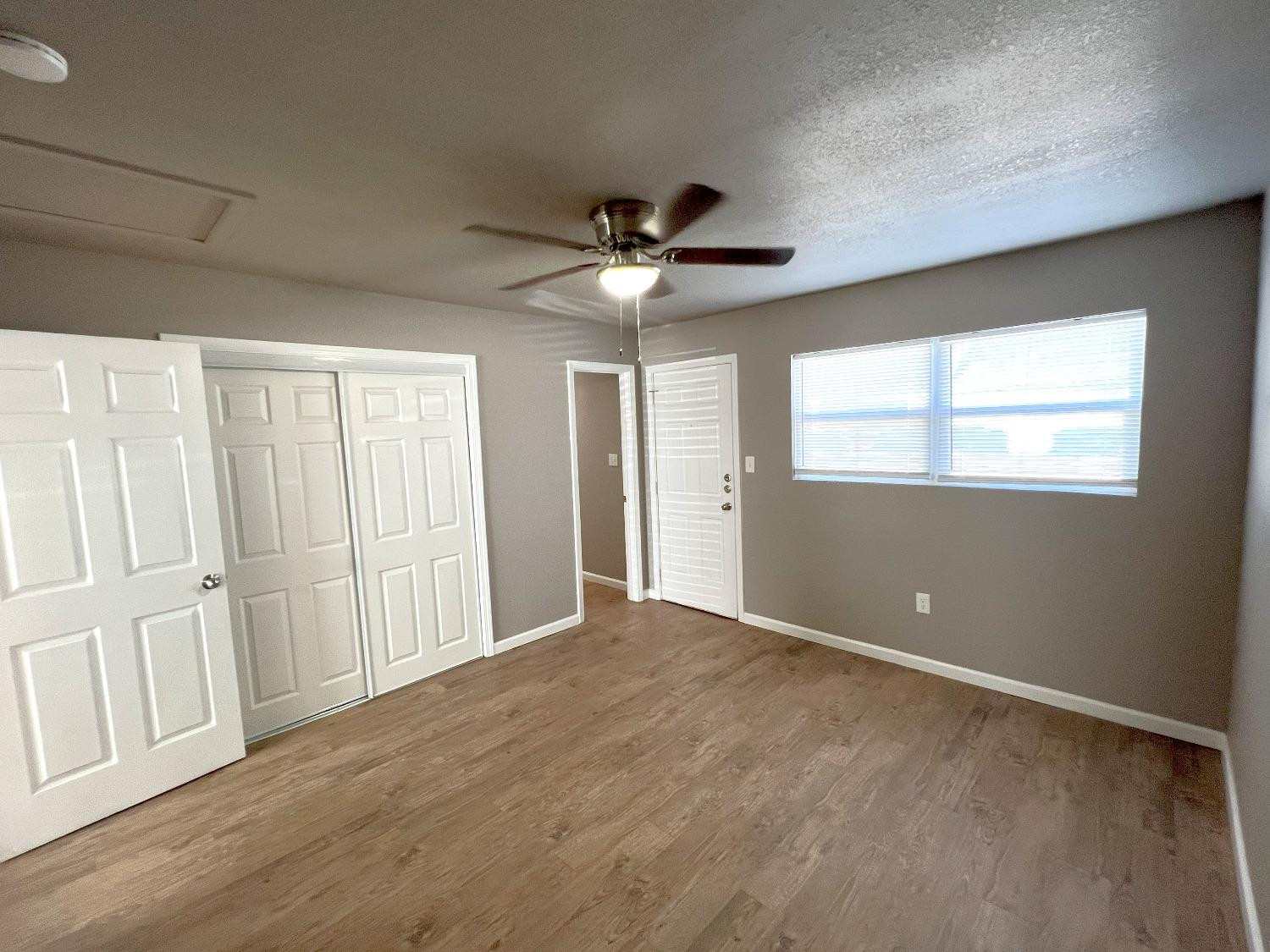 1201 36th Street, Unit C Lubbock, TX 79412 - Photo 6 of 7 a view of an empty room with a window