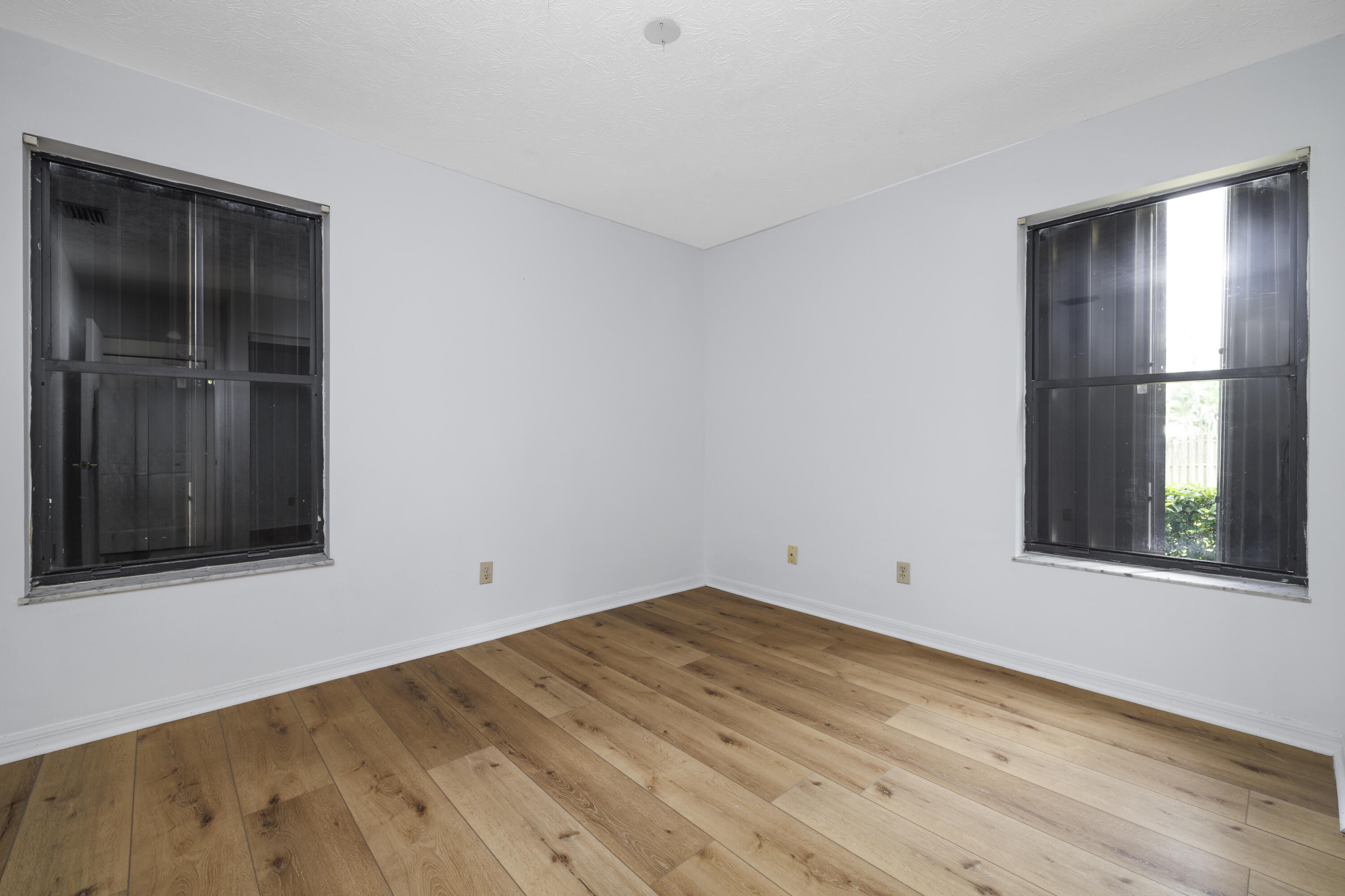 6541 Southeast Federal Highway, Unit 101 Stuart, FL 34997 - Photo 13 of 30 wooden floor in an empty room with a window