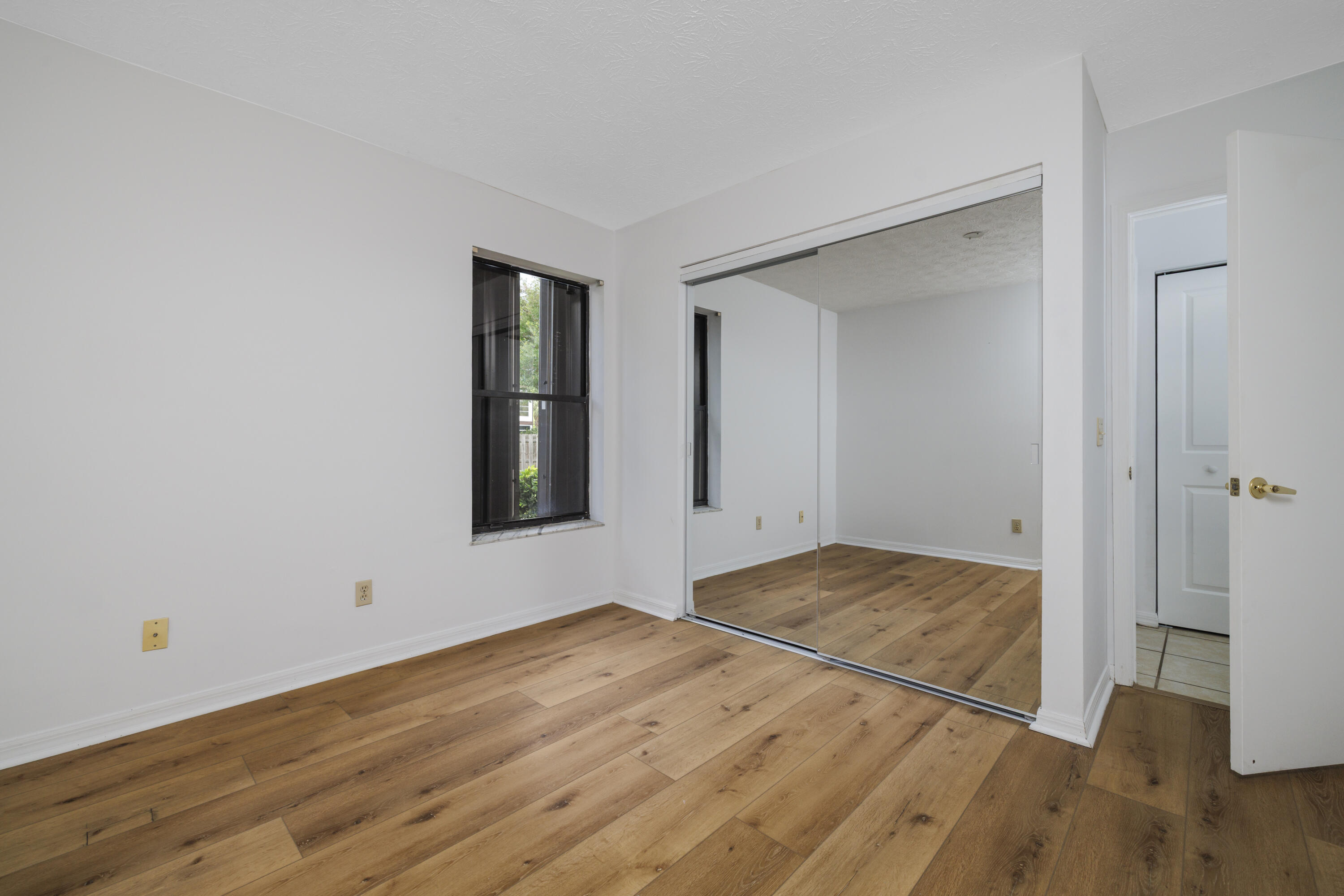6541 Southeast Federal Highway, Unit 101 Stuart, FL 34997 - Photo 14 of 30 a view of empty room with wooden floor