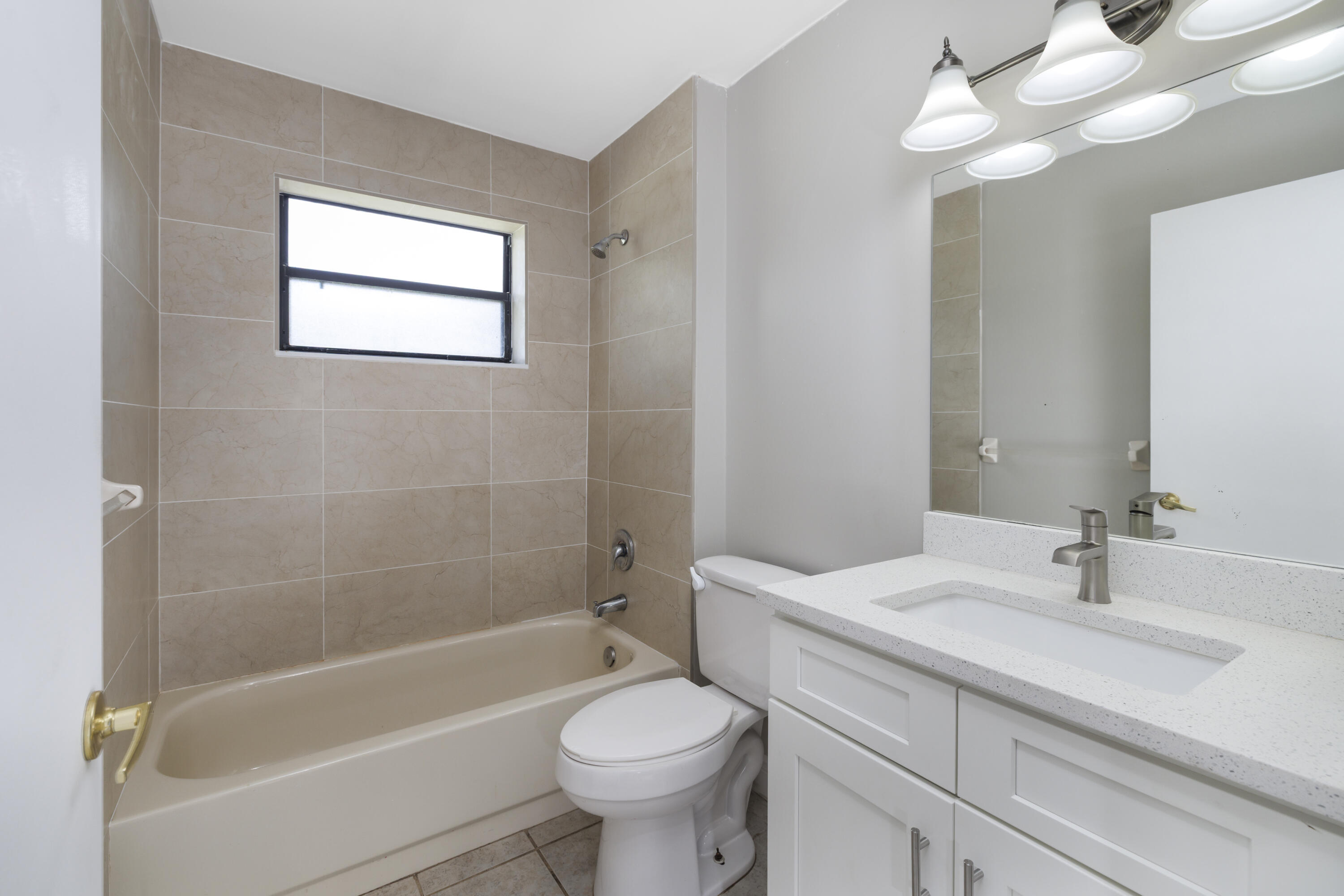 6541 Southeast Federal Highway, Unit 101 Stuart, FL 34997 - Photo 15 of 30 a bathroom with a sink a toilet and a bathtub