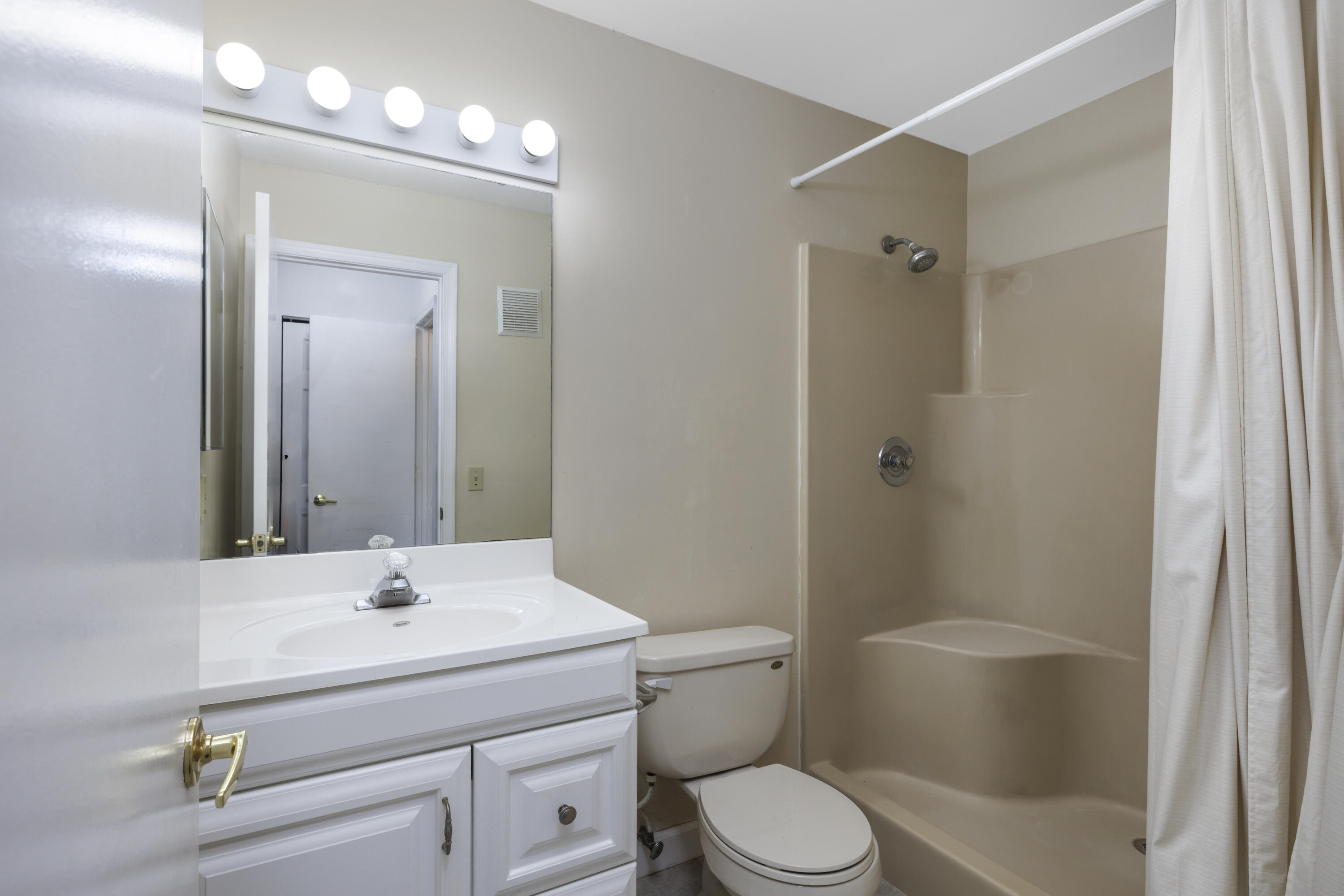 6541 Southeast Federal Highway, Unit 101 Stuart, FL 34997 - Photo 18 of 30 a bathroom with a sink a toilet and shower