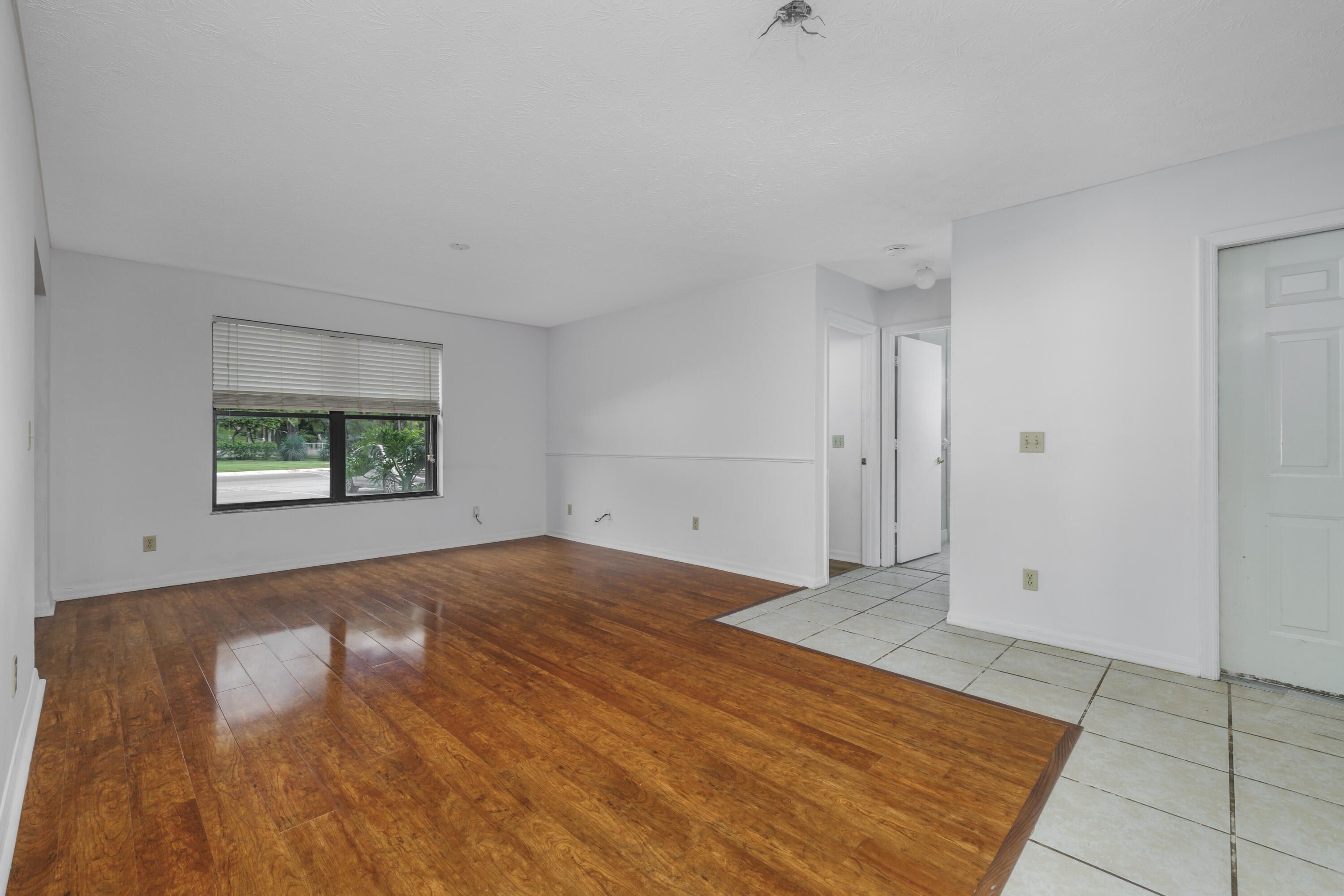 6541 Southeast Federal Highway, Unit 101 Stuart, FL 34997 - Photo 6 of 30 wooden floor in an empty room