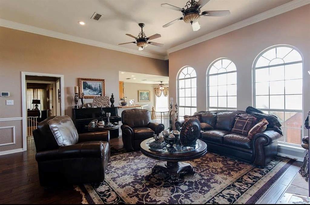 10899 Jackson Road Krum, TX 76249 - Photo 10 of 11 Living area featuring hardwood / wood-style floors, crown molding, and ceiling fan