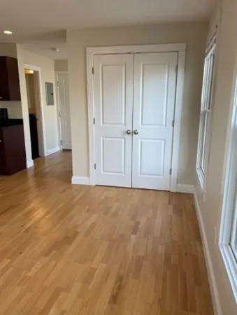 a view of an empty room with wooden door