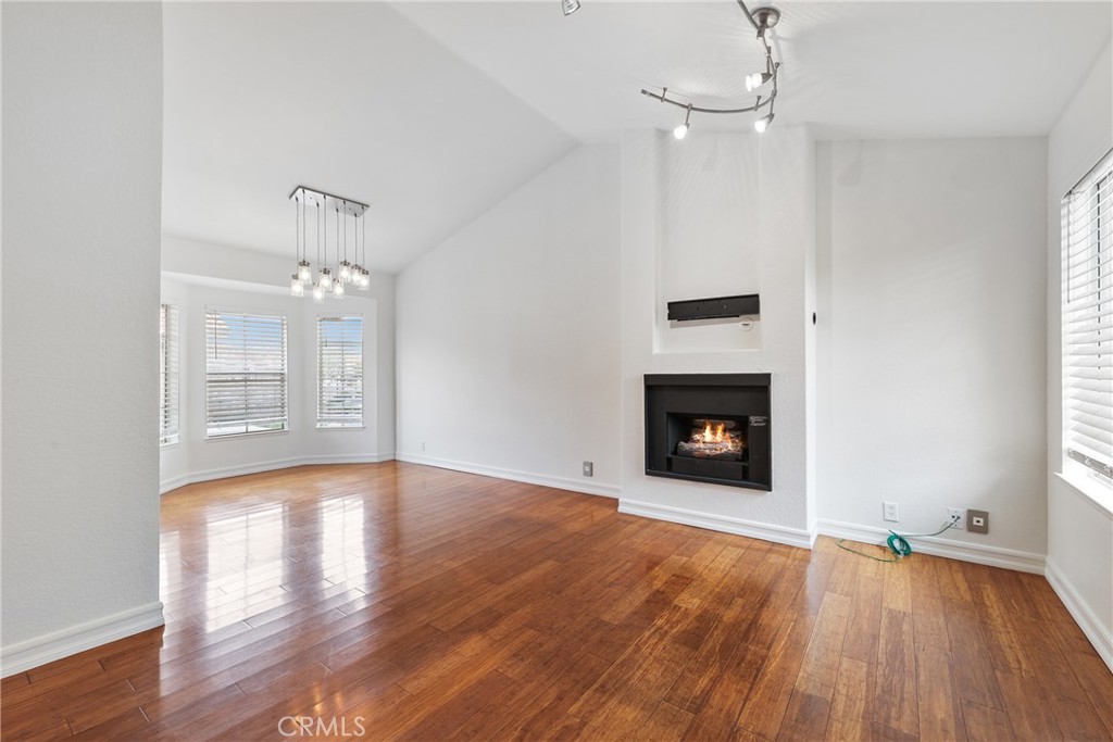 4 Dogwood Rancho Santa Margarita, CA 92688 - Photo 1 of 18 a view of an empty room with wooden floor fireplace and a window