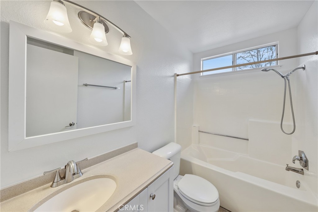 4 Dogwood Rancho Santa Margarita, CA 92688 - Photo 14 of 18 a bathroom with a granite countertop sink toilet mirror and shower