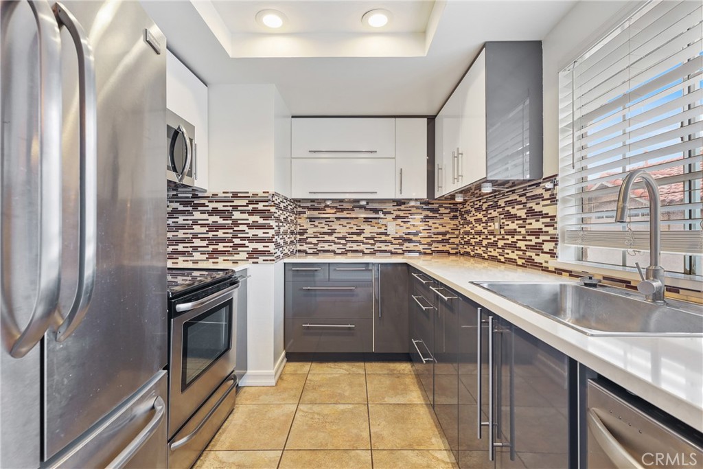 4 Dogwood Rancho Santa Margarita, CA 92688 - Photo 5 of 18 a kitchen with stainless steel appliances granite countertop a sink stove and refrigerator