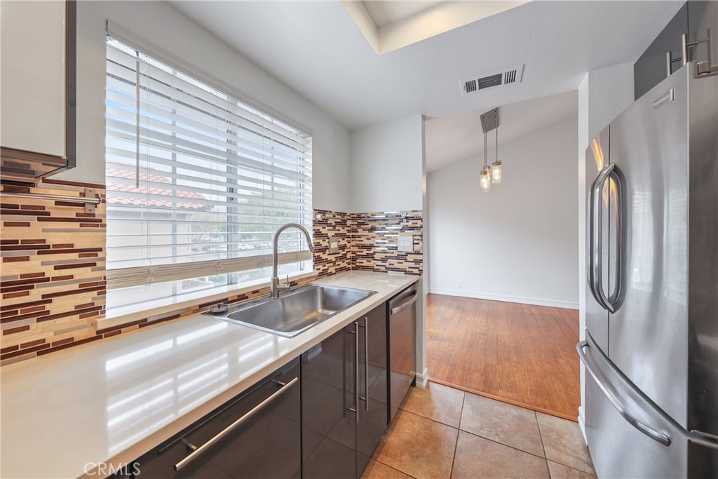 4 Dogwood Rancho Santa Margarita, CA 92688 - Photo 7 of 18 a kitchen with a sink and a refrigerator