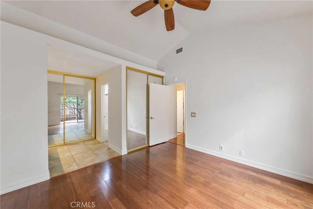 4 Dogwood Rancho Santa Margarita, CA 92688 - Photo 9 of 18 an empty room with wooden floor cabinet and windows