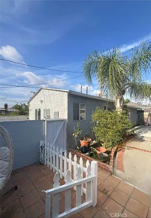 a front view of house along with deck and outdoor seating