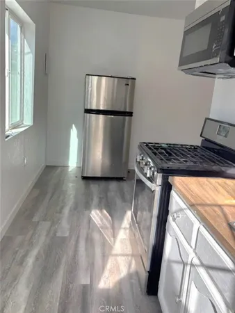 a kitchen with a refrigerator and a stove