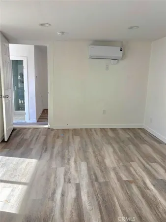 a view of a room with wooden floor
