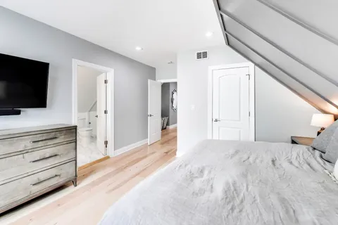 a bedroom with a bed and flat screen tv