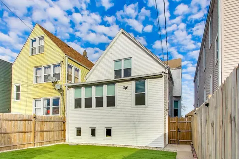 a view of a house with a yard and sitting space
