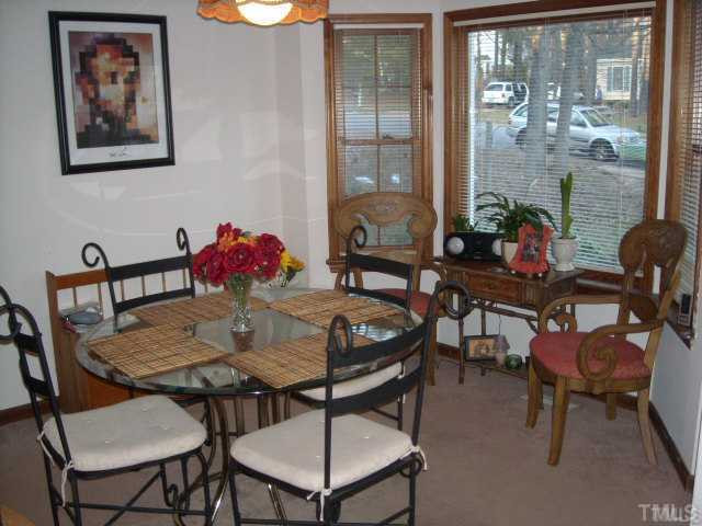 6917 Glendower Road, Unit B Raleigh, NC 27613 - Photo 2 of 5 a view of a dining room with furniture window and outside view
