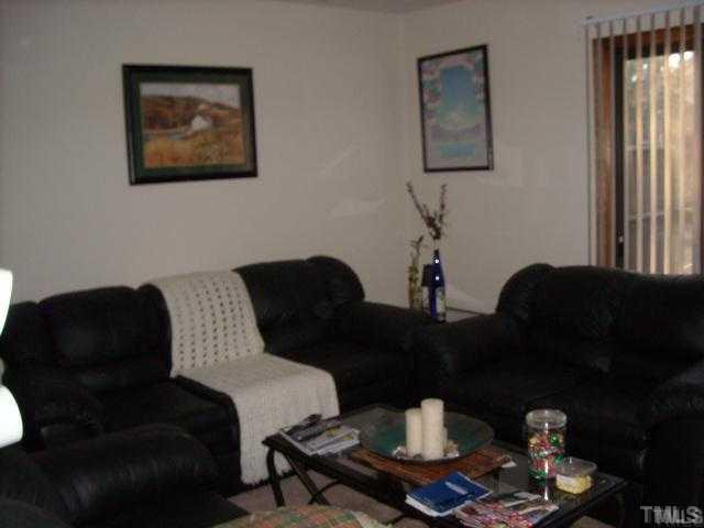 6917 Glendower Road, Unit B Raleigh, NC 27613 - Photo 3 of 5 a living room with furniture and wooden floor