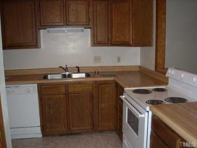 6917 Glendower Road, Unit B Raleigh, NC 27613 - Photo 4 of 5 a kitchen with granite countertop a sink stove and cabinets