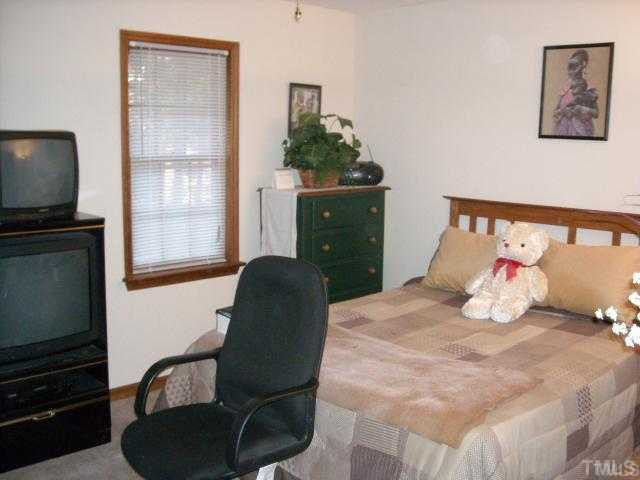 6917 Glendower Road, Unit B Raleigh, NC 27613 - Photo 5 of 5 a bedroom with a bed flat screen tv and dresser