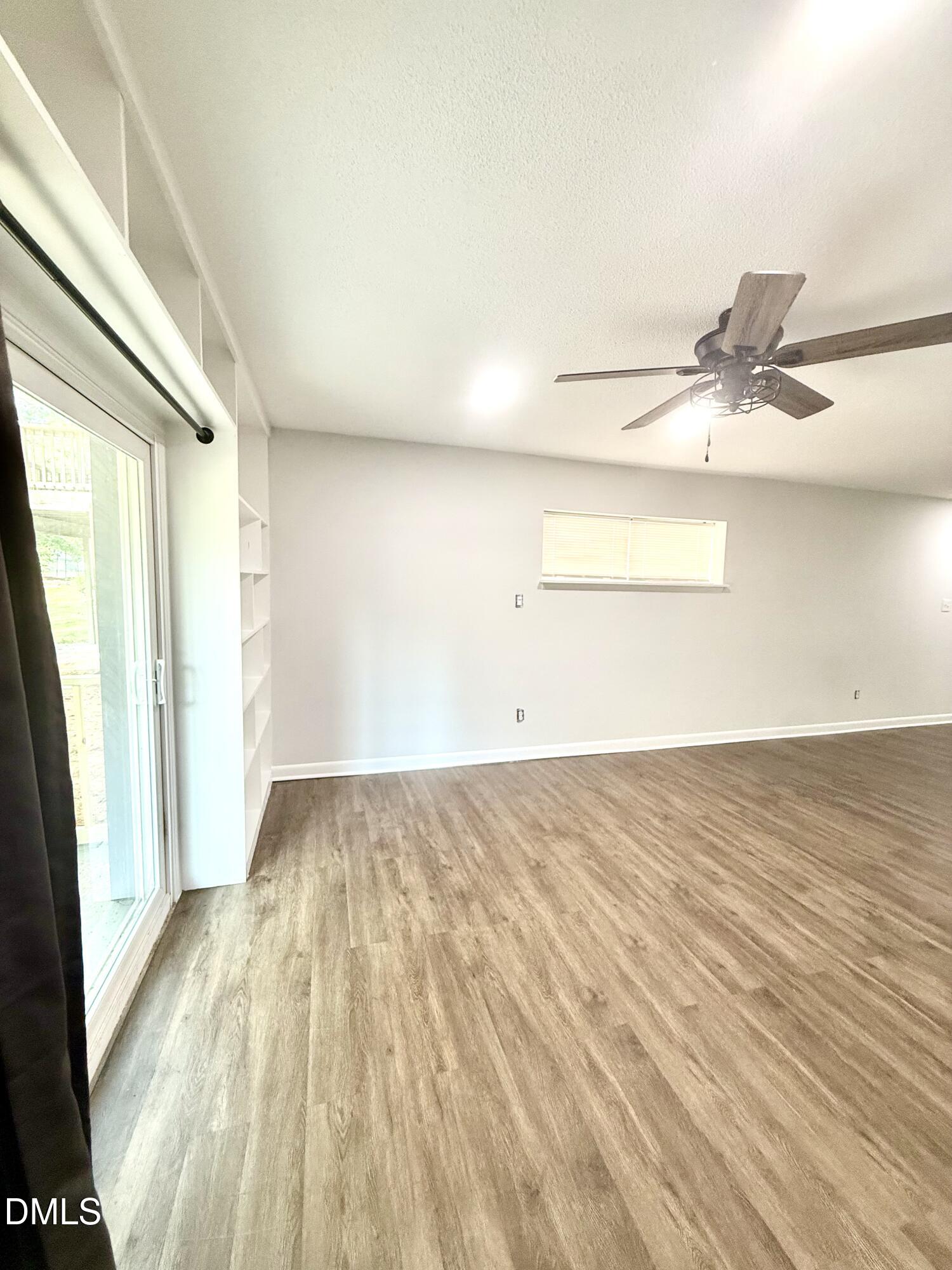 546 Pine Ridge Place Raleigh, NC 27609 - Photo 4 of 28 a view of a room with wooden floor and white walls