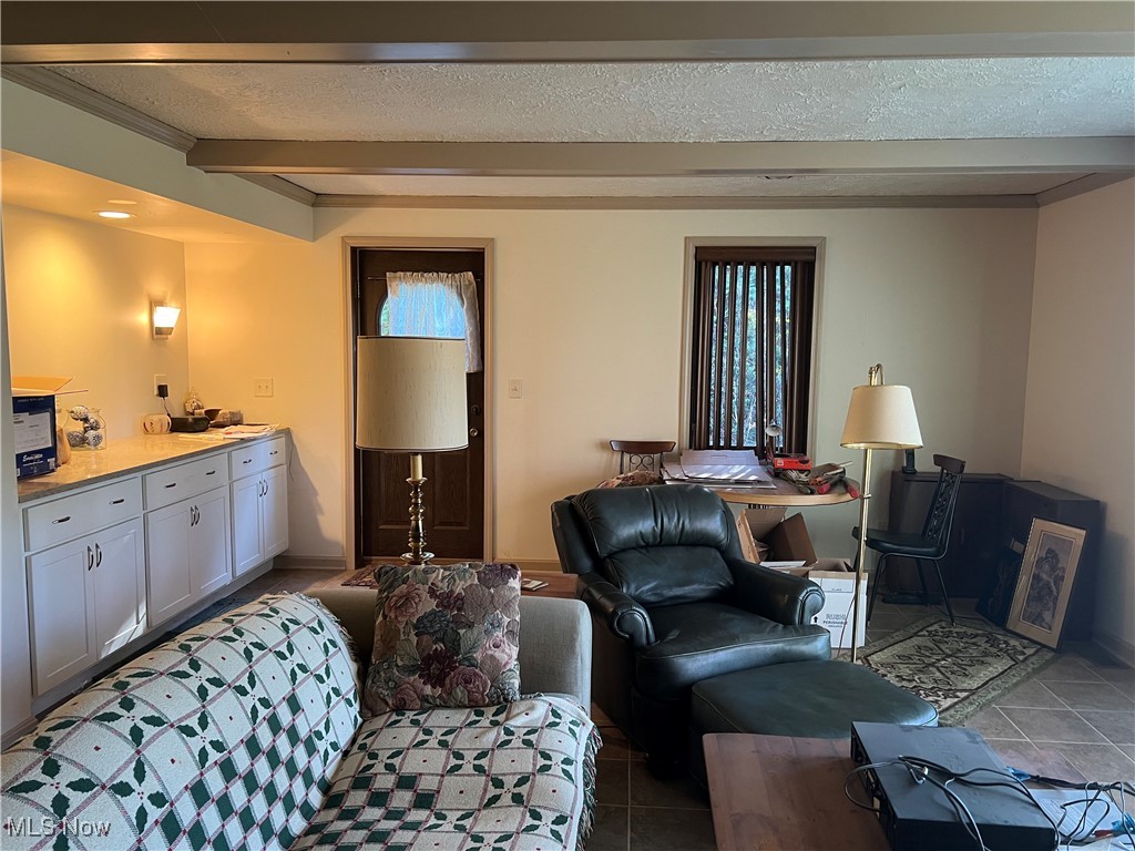 3330 Stanley Road Akron, OH 44333 - Photo 10 of 22 Living room with tile patterned flooring and a textured ceiling