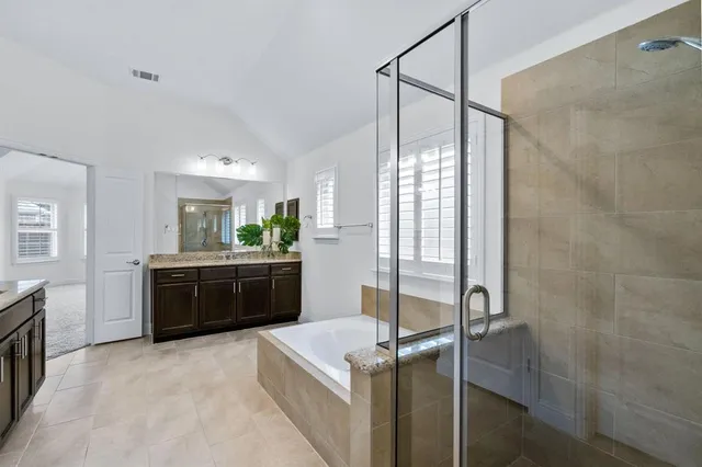 a spacious bathroom with a granite countertop tub and a sink