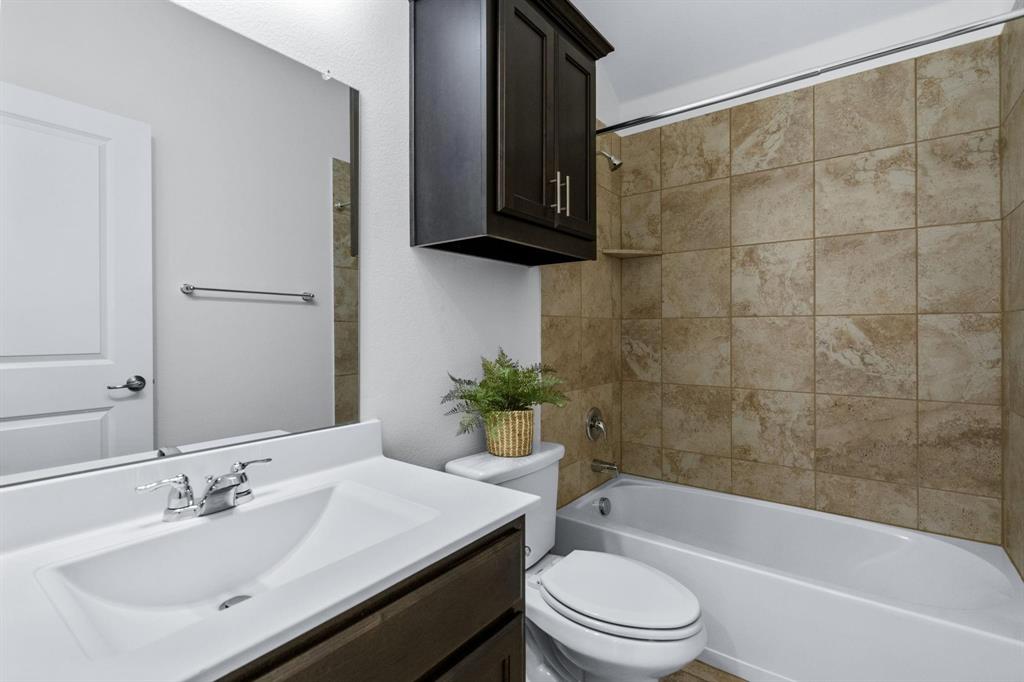 4220 Harper Avenue Celina, TX 75009 - Photo 16 of 20 a bathroom with a sink a toilet and bathtub