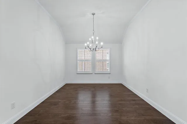 a view of a room with windows and chandelier