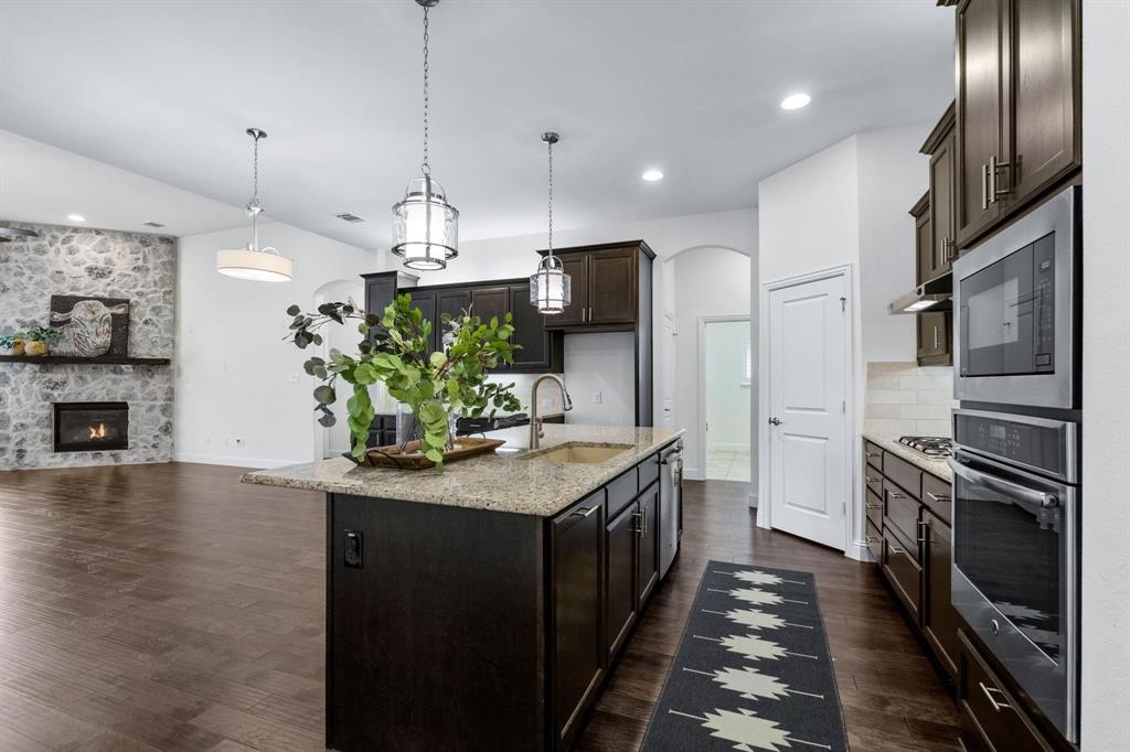 4220 Harper Avenue Celina, TX 75009 - Photo 20 of 20 a kitchen with stainless steel appliances granite countertop a sink a stove and a refrigerator