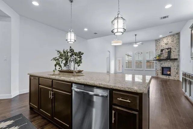 a kitchen with stainless steel appliances granite countertop a sink stove and cabinets