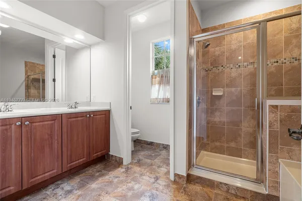 a bathroom with a shower and a sink