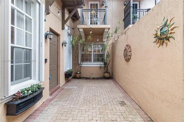 a view of a house with potted plants