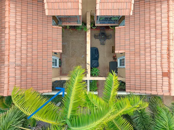 an aerial view of a house with garden space and street view