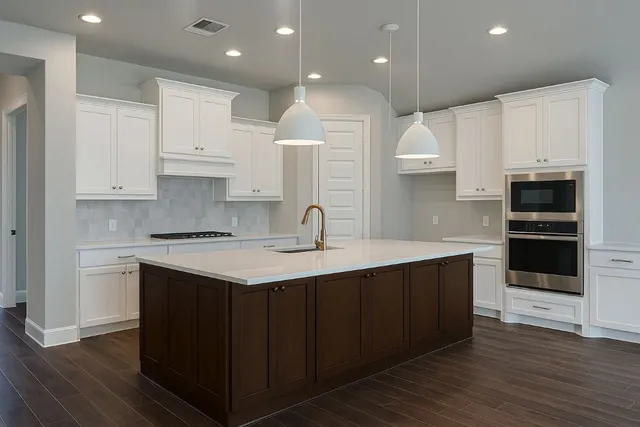 a kitchen with kitchen island granite countertop a sink stainless steel appliances and cabinets