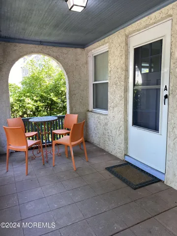 a view of a porch with chairs and a potted plant