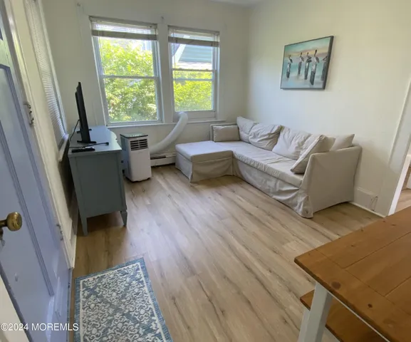 a living room with furniture and a rug