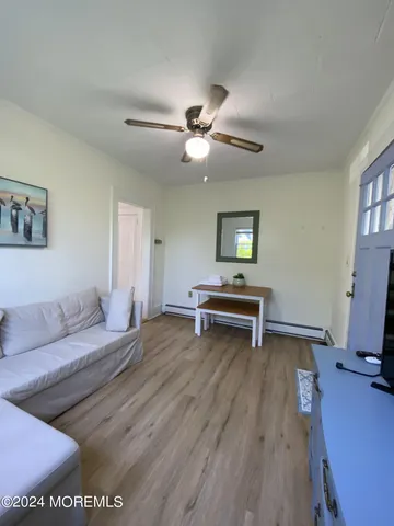 a bedroom with a bed and a ceiling fan