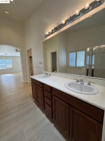 a spacious bathroom with a double vanity sink and a mirror