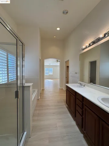 a spacious bathroom with a double vanity sink and mirror