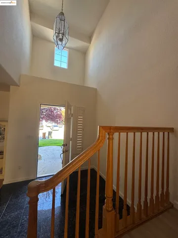 a view of staircase with railing and white walls