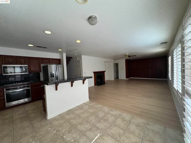 a view of a livingroom with a fireplace a window and a fireplace