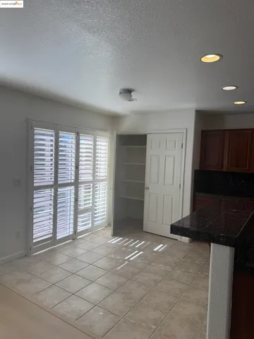 a view of kitchen with furniture and refrigerator