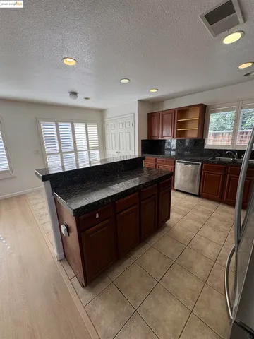 a kitchen with a stove a sink a microwave a counter top space and cabinets