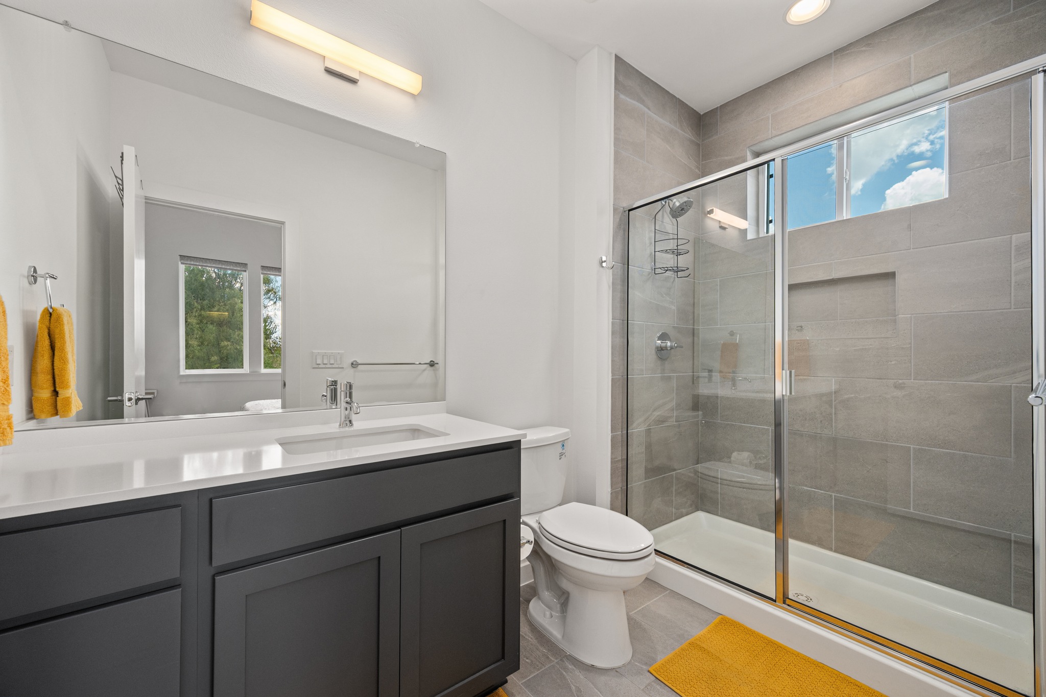 1190 Sarabeth Way Austin, TX 78721 - Photo 13 of 22 Modern stone-tiled walk-in shower highlights this sleek contemporary bathroom with clean finishes.