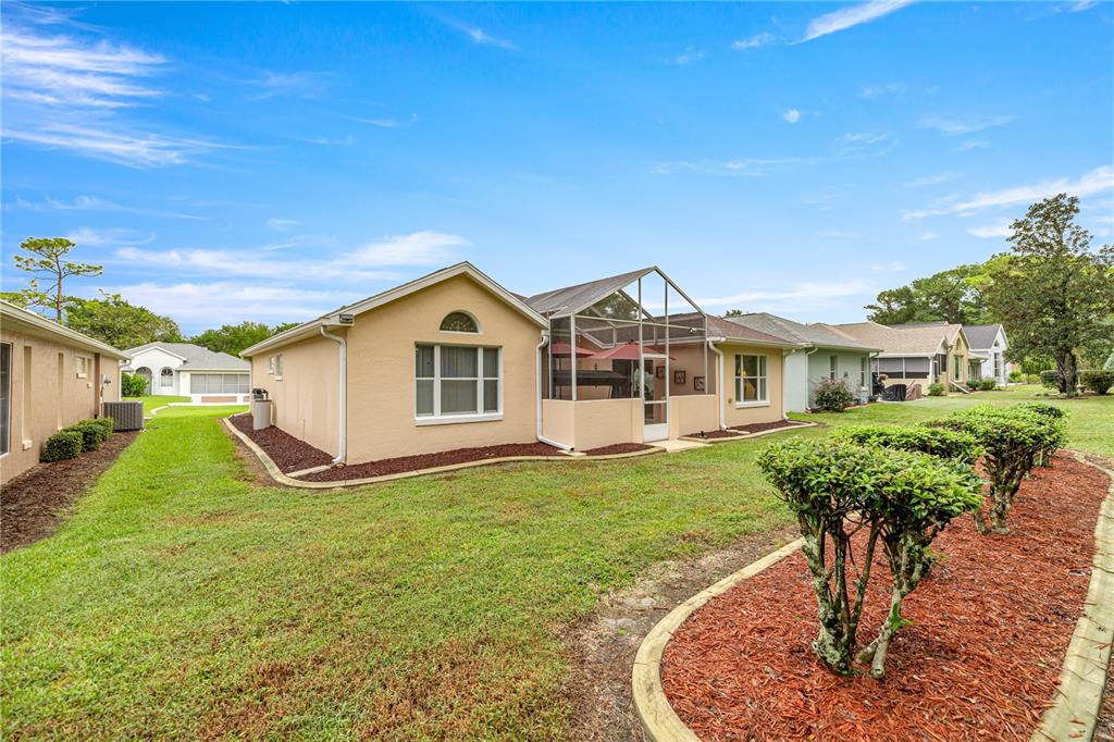 11298 Southwest 73rd Circle Ocala, FL 34476 - Photo 14 of 14 a front view of a house with garden