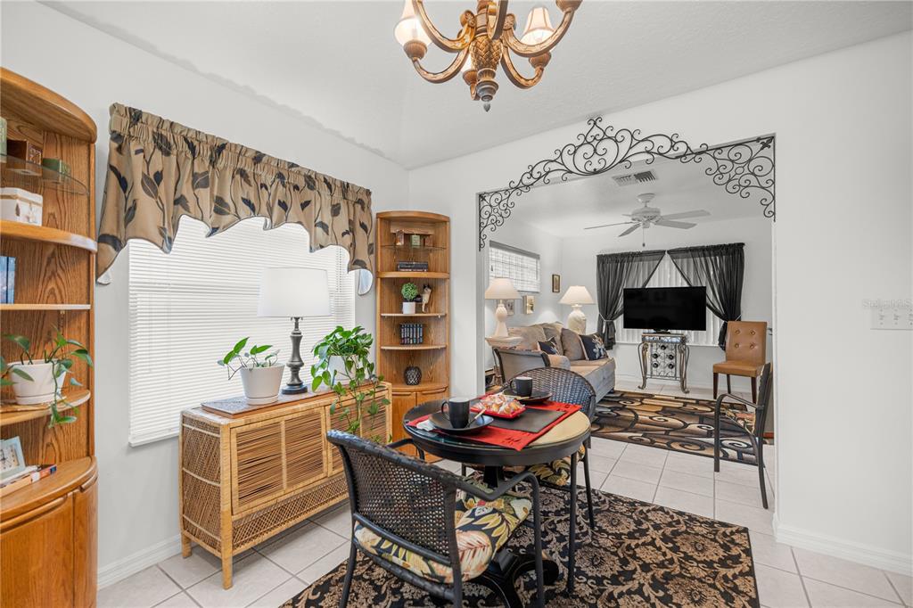 11298 Southwest 73rd Circle Ocala, FL 34476 - Photo 6 of 14 a living room with furniture a flat screen tv and a table