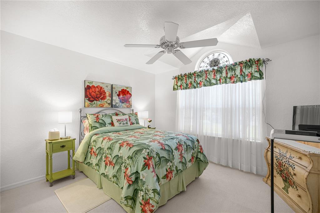 11298 Southwest 73rd Circle Ocala, FL 34476 - Photo 9 of 14 a bedroom with a bed and a flat tv screen on dresser